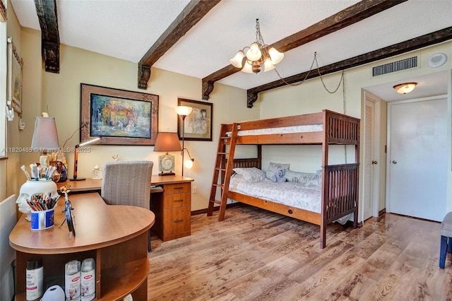 1833 S Ocean Dr Unit 1402, Hallandale Beach, FL 33009 - bedroom with beamed ceiling, a chandelier, light wood finished floors, and a textured ceiling