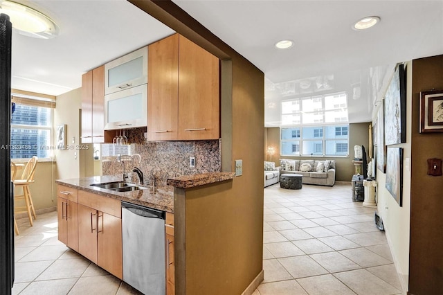 1833 S Ocean Dr Unit 1402, Hallandale Beach, FL 33009 - kitchen with stainless steel dishwasher, light tile patterned floors, stone counters, tasteful backsplash, and recessed lighting