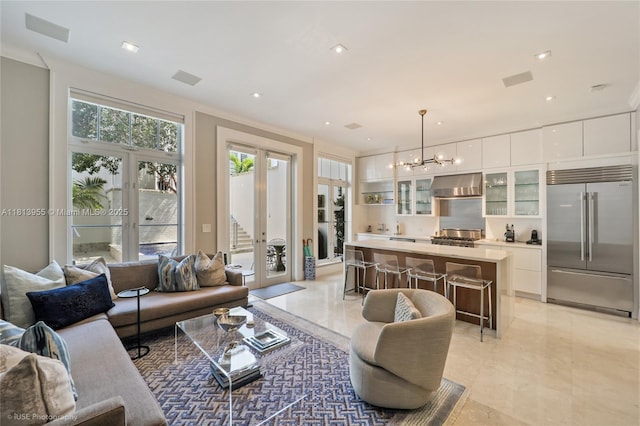 647 Almeria Ave, Coral Gables, FL 33134 - living area featuring a chandelier, light tile patterned flooring, and recessed lighting