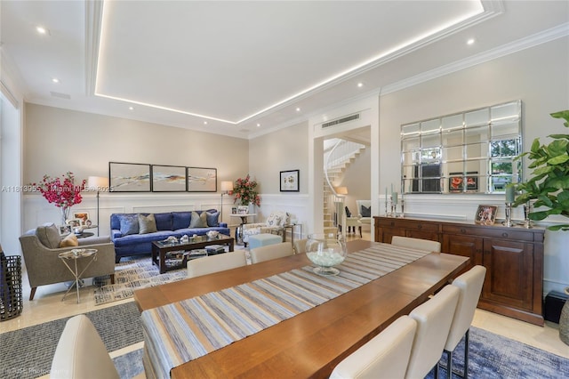 647 Almeria Ave, Coral Gables, FL 33134 - dining room featuring a raised ceiling, stairs, recessed lighting, wainscoting, and crown molding