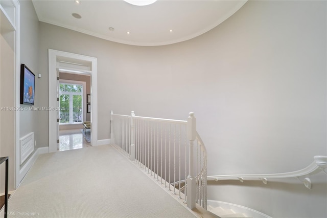 647 Almeria Ave, Coral Gables, FL 33134 - hallway with an upstairs landing, crown molding, and carpet flooring