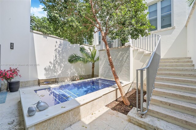 647 Almeria Ave, Coral Gables, FL 33134 - view of swimming pool featuring stairway and a hot tub