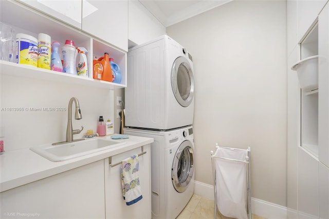 647 Almeria Ave, Coral Gables, FL 33134 - laundry area with stacked washer / dryer, crown molding, and light tile patterned floors