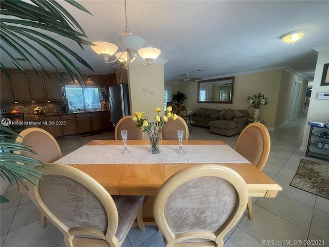 411 Martin Rd, Margate, FL 33068 - dining area featuring a chandelier, light tile patterned floors, a ceiling fan, and ornamental molding