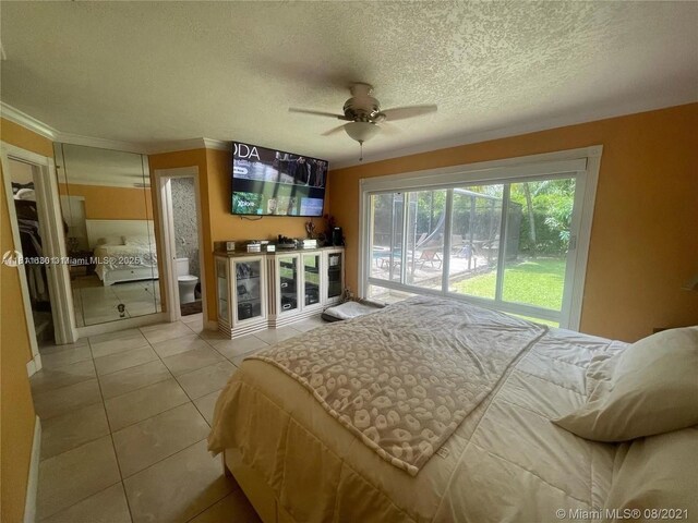 411 Martin Rd, Margate, FL 33068 - bedroom featuring a textured ceiling, light tile patterned floors, ornamental molding, and ceiling fan