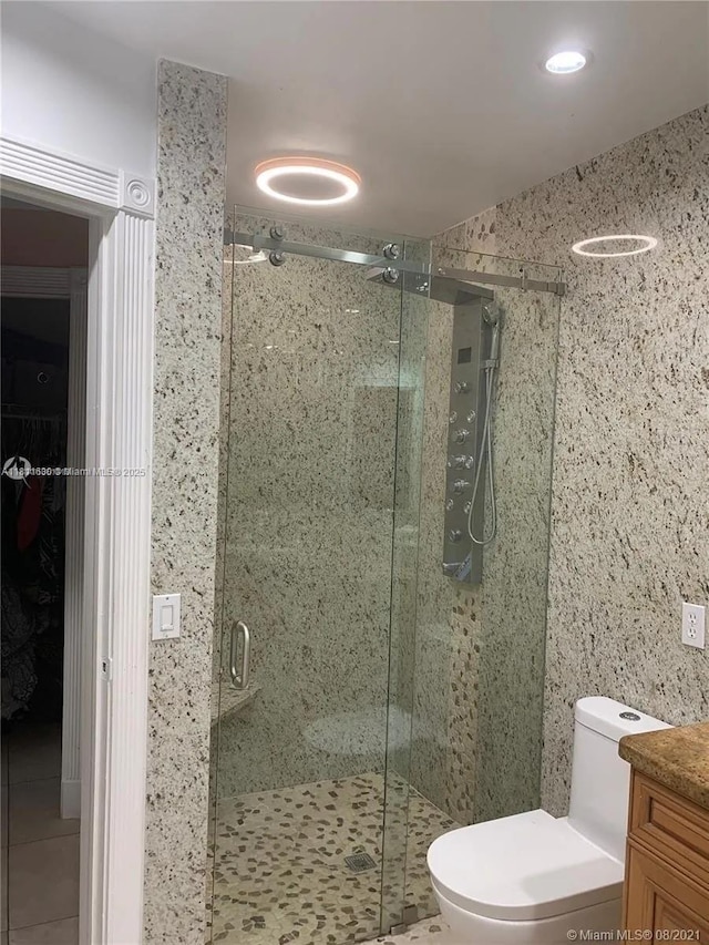 411 Martin Rd, Margate, FL 33068 - full bathroom featuring a stall shower, vanity, a walk in closet, and tile patterned floors
