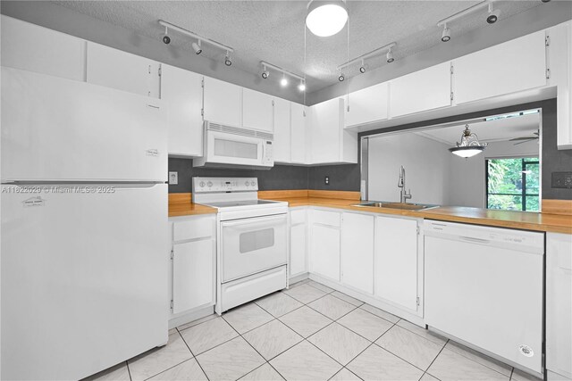 502 Westree Ln, Plantation, FL 33324 - kitchen with white appliances, white cabinets, light tile patterned flooring, and a textured ceiling