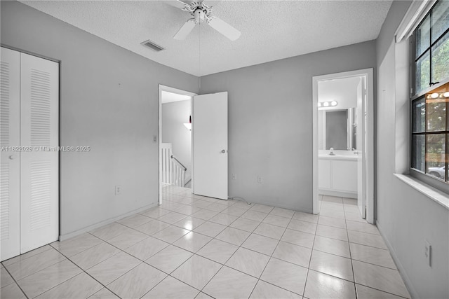 502 Westree Ln, Plantation, FL 33324 - unfurnished bedroom with a textured ceiling, light tile patterned floors, ceiling fan, and connected bathroom