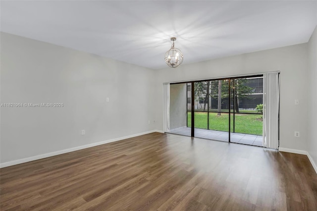 511 Ives Dairy Rd Unit 104-6, Miami, FL 33179 - unfurnished room with a chandelier and wood finished floors