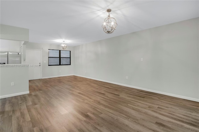 511 Ives Dairy Rd Unit 104-6, Miami, FL 33179 - unfurnished room with a chandelier and wood finished floors