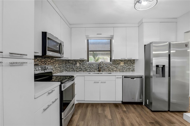 511 Ives Dairy Rd Unit 104-6, Miami, FL 33179 - kitchen with appliances with stainless steel finishes, dark wood-style floors, light countertops, and white cabinets