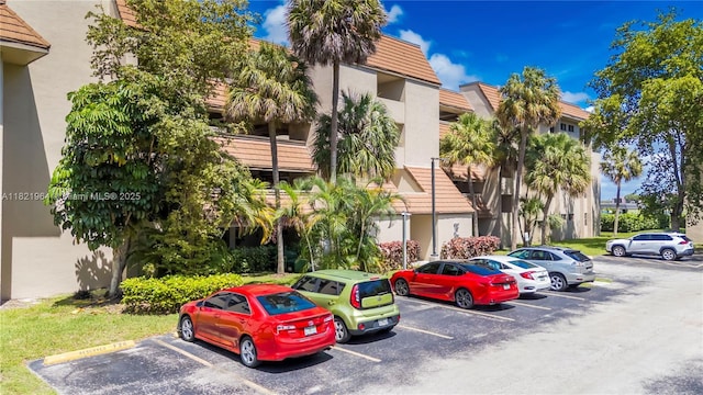 511 Ives Dairy Rd Unit 104-6, Miami, FL 33179 - view of building exterior with uncovered parking