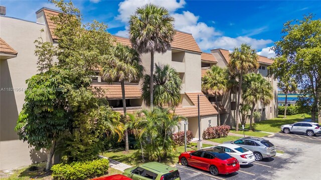 511 Ives Dairy Rd Unit 104-6, Miami, FL 33179 - view of building exterior featuring uncovered parking