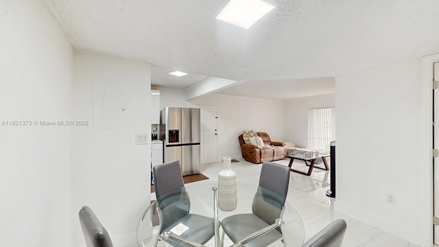 7180 NW 179th St Unit 105, Hialeah, FL 33015 - dining space with a textured ceiling and light marble finish flooring