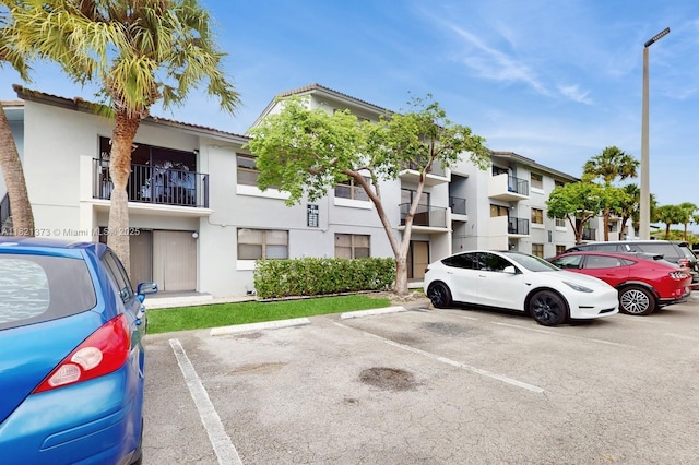 7180 NW 179th St Unit 105, Hialeah, FL 33015 - view of building exterior with uncovered parking