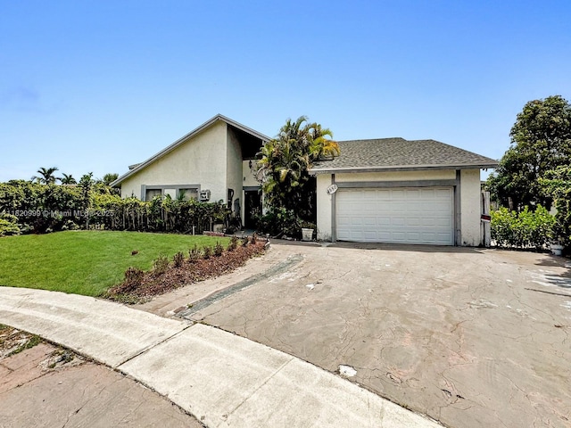 4550 NW 65th Way, Lauderhill, FL 33319 - mid-century home featuring stucco siding, a front yard, asphalt driveway, and a garage