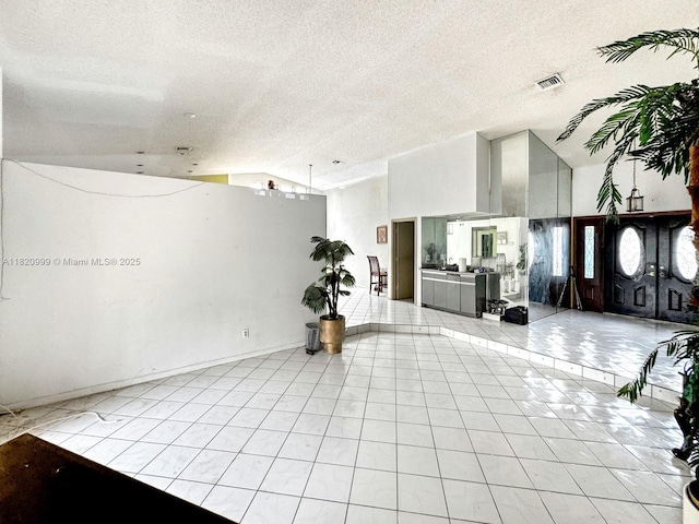 4550 NW 65th Way, Lauderhill, FL 33319 - building lobby featuring lofted ceiling and a textured ceiling