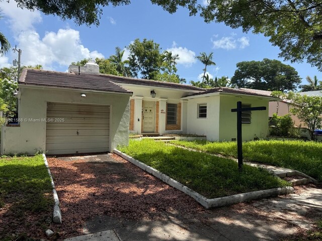 531 NE 55th Ter, Miami, FL 33137 - ranch-style home featuring driveway, an attached garage, stucco siding, a chimney, and a tiled roof