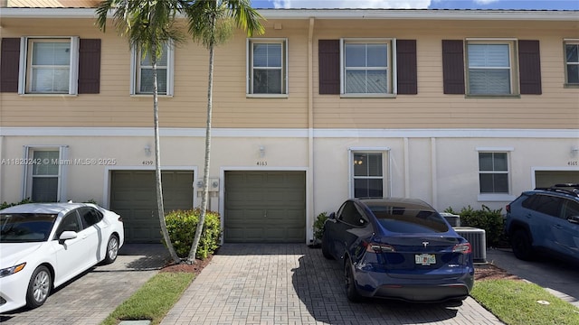 4163 Maya Cay Ln, Jupiter, FL 33458 - view of front facade with an attached garage, driveway, and stucco siding