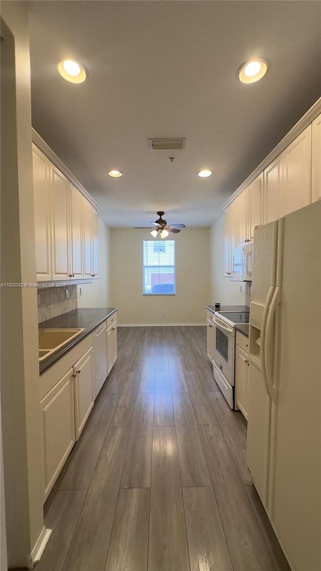 4163 Maya Cay Ln, Jupiter, FL 33458 - kitchen featuring white appliances, dark countertops, a ceiling fan, white cabinets, and recessed lighting