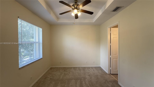 4163 Maya Cay Ln, Jupiter, FL 33458 - spare room featuring a tray ceiling, a ceiling fan, and carpet flooring