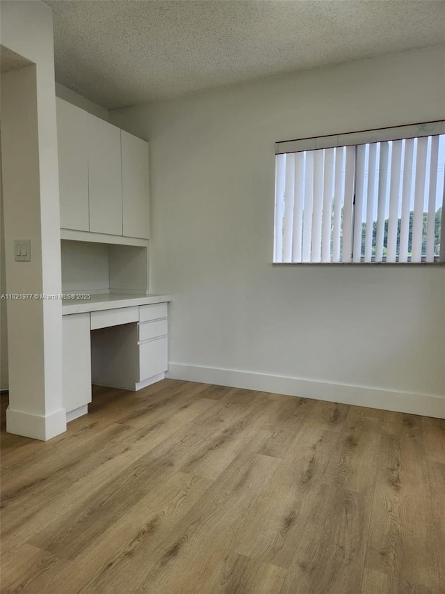 12755 SW 16th Ct Unit 201B, Pembroke Pines, FL 33027 - unfurnished office featuring built in study area, light wood-style flooring, and a textured ceiling