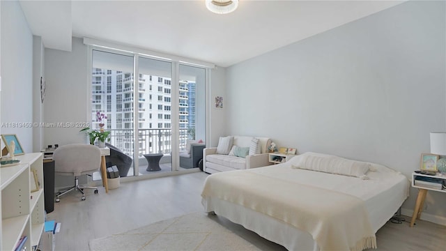 801 Brickell Key Blvd Unit 2210, Miami, FL 33131 - bedroom featuring wood finished floors, access to outside, and expansive windows