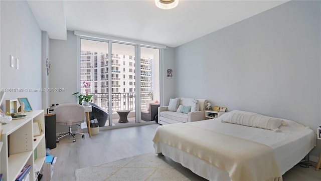 801 Brickell Key Blvd Unit 2210, Miami, FL 33131 - bedroom featuring wood finished floors, expansive windows, and access to outside