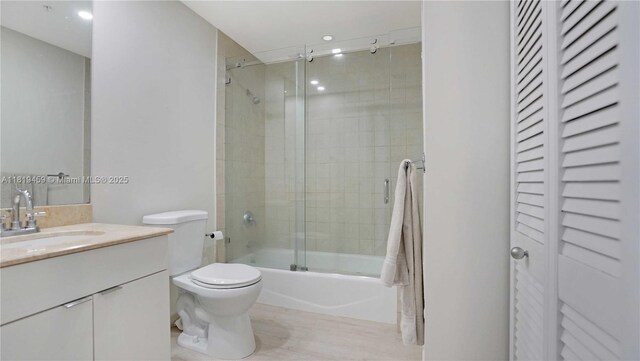 801 Brickell Key Blvd Unit 2210, Miami, FL 33131 - bathroom with vanity, combined bath / shower with glass door, a closet, and wood finished floors