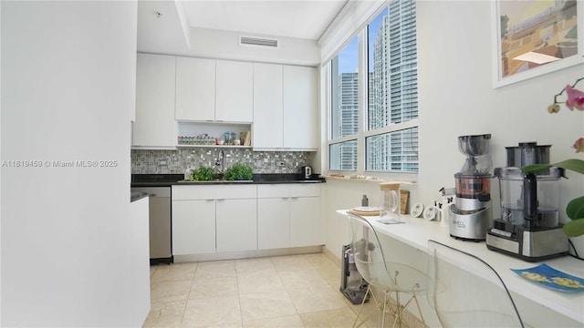 801 Brickell Key Blvd Unit 2210, Miami, FL 33131 - kitchen featuring decorative backsplash, white cabinetry, open shelves, dark countertops, and dishwasher