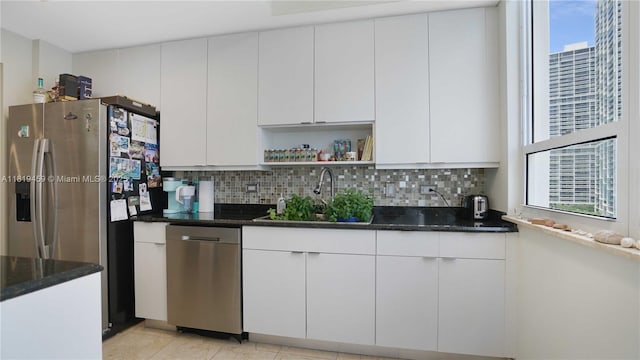 801 Brickell Key Blvd Unit 2210, Miami, FL 33131 - kitchen with stainless steel appliances, backsplash, dark stone countertops, and open shelves