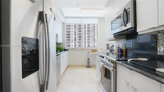 801 Brickell Key Blvd Unit 2210, Miami, FL 33131 - kitchen featuring appliances with stainless steel finishes, tasteful backsplash, white cabinets, and dark countertops