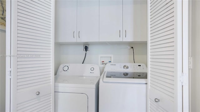 801 Brickell Key Blvd Unit 2210, Miami, FL 33131 - laundry area with washing machine and clothes dryer and cabinet space
