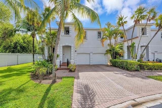 21235 NE 33rd Ave, Aventura, FL 33180 - view of front of property featuring decorative driveway, stucco siding, and a garage