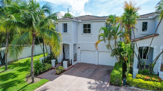 21235 NE 33rd Ave, Aventura, FL 33180 - mediterranean / spanish home with a tiled roof, stucco siding, decorative driveway, and an attached garage