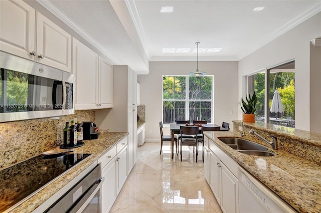21235 NE 33rd Ave, Aventura, FL 33180 - kitchen with stainless steel microwave, oven, tasteful backsplash, light marble finish floors, and ornamental molding