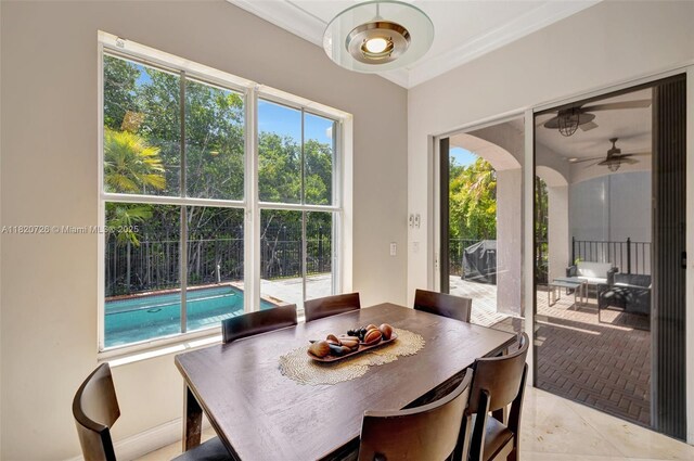 21235 NE 33rd Ave, Aventura, FL 33180 - dining area with healthy amount of natural light, a ceiling fan, ornamental molding, and light tile patterned flooring