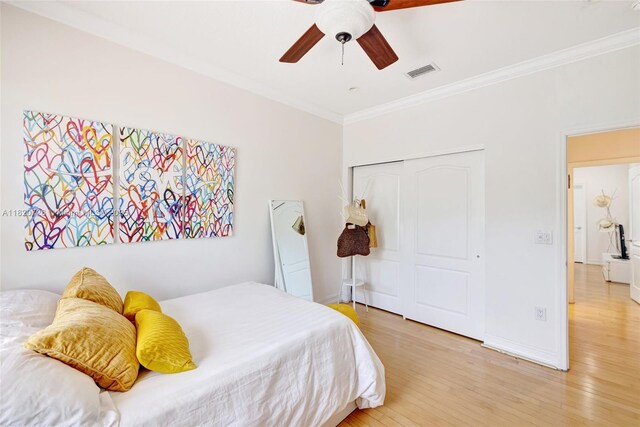 21235 NE 33rd Ave, Aventura, FL 33180 - bedroom featuring ornamental molding, wood finished floors, a closet, and a ceiling fan
