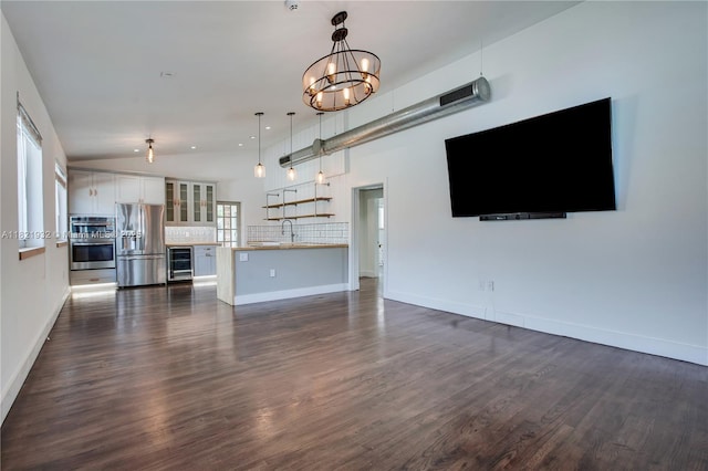 2305 SW 19th Ter, Miami, FL 33145 - unfurnished living room featuring beverage cooler, dark wood-style flooring, a chandelier, and lofted ceiling