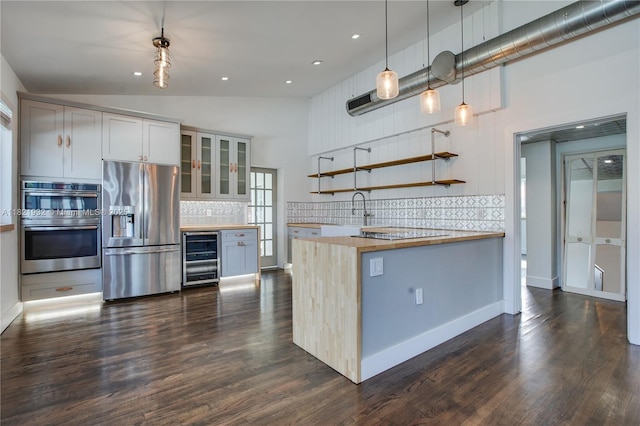 2305 SW 19th Ter, Miami, FL 33145 - kitchen featuring stainless steel appliances, beverage cooler, butcher block counters, backsplash, and glass insert cabinets