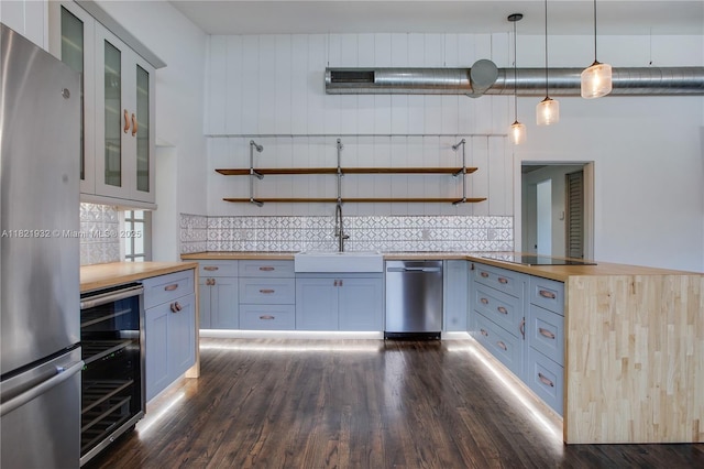 2305 SW 19th Ter, Miami, FL 33145 - kitchen with appliances with stainless steel finishes, butcher block countertops, beverage cooler, and backsplash