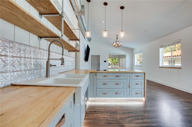 2305 SW 19th Ter, Miami, FL 33145 - kitchen with butcher block counters, dark wood-type flooring, open shelves, a peninsula, and lofted ceiling