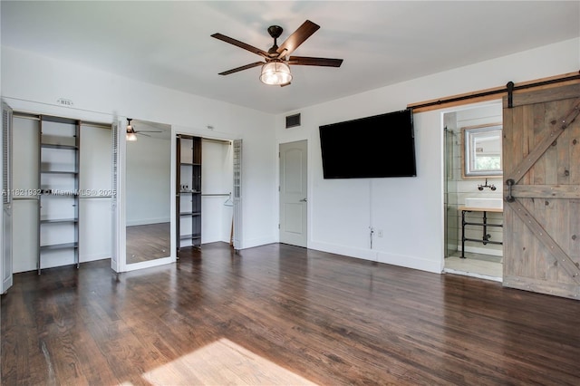 2305 SW 19th Ter, Miami, FL 33145 - unfurnished living room with a barn door, a ceiling fan, and wood finished floors