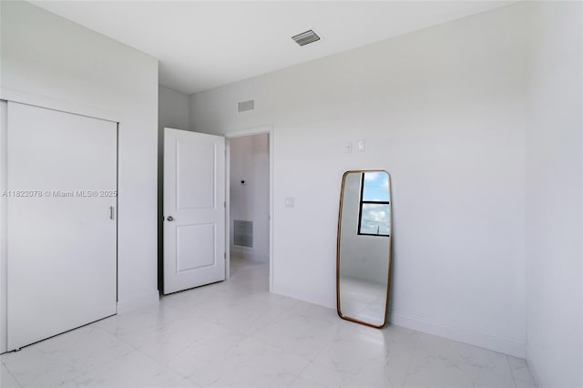 6032 Keystone Cir, La Belle, FL 33935 - unfurnished bedroom with light marble finish floors and baseboards