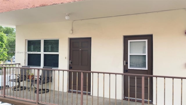 415 NE 2nd St Unit 223, Hallandale Beach, FL 33009 - view of exterior entry featuring stucco siding and a porch
