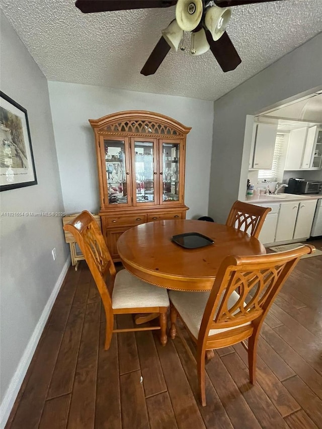 415 NE 2nd St Unit 223, Hallandale Beach, FL 33009 - dining space featuring dark wood-style floors, a ceiling fan, and a textured ceiling