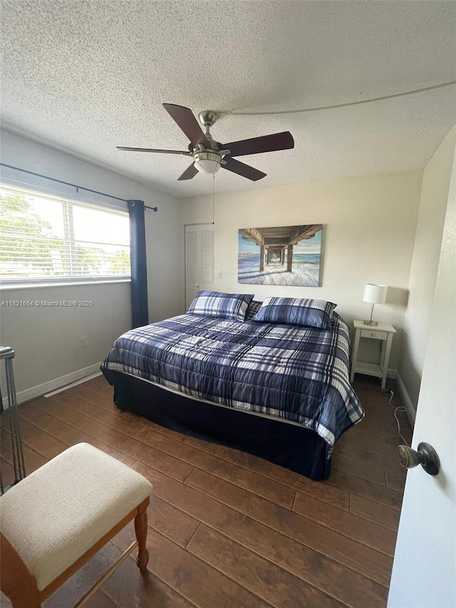 415 NE 2nd St Unit 223, Hallandale Beach, FL 33009 - bedroom featuring wood finished floors, a textured ceiling, and a ceiling fan