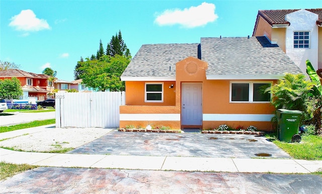 1061 SE 13th Ave Unit 1061, Homestead, FL 33035 - bungalow featuring stucco siding, a shingled roof, and a residential view
