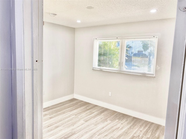 1061 SE 13th Ave Unit 1061, Homestead, FL 33035 - unfurnished room with wood finished floors, a textured ceiling, and recessed lighting