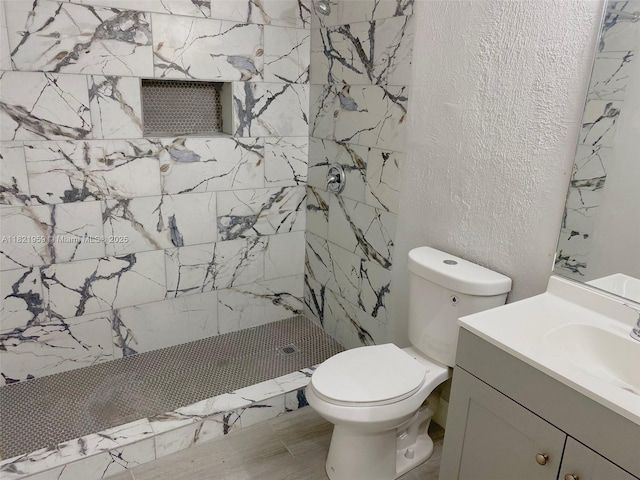1061 SE 13th Ave Unit 1061, Homestead, FL 33035 - bathroom featuring a shower stall, vanity, and a textured wall